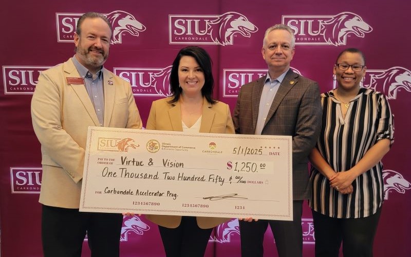 Virtue & Vision's Lindsey Zollner accepting ceremonial check. 